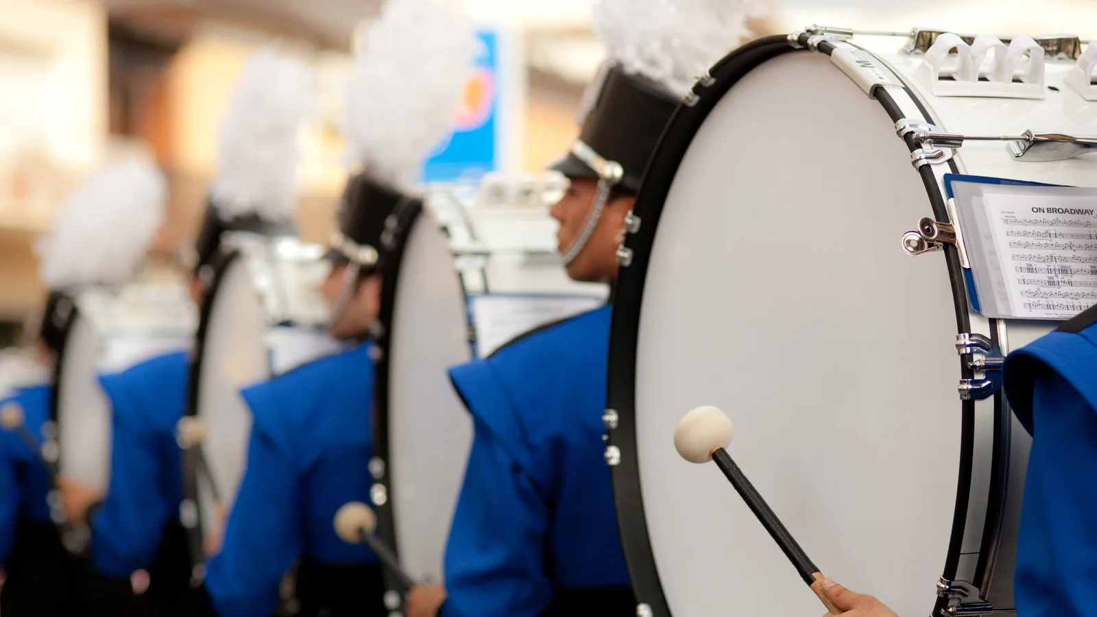 London Sent Five People to Mineola to Invite One Marching Band